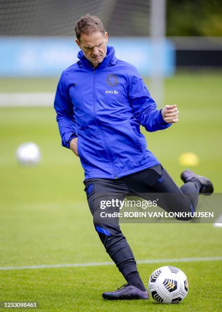 Head coach Frank de Boer kicks the ball as Dutch national football team players attend a training session at the KNVB Campus on May 25, 2021 in...