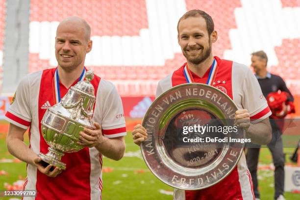 Davy Klaassen of Ajax Amsterdam and Daley Blind of Ajax Amsterdam look with the trophies in their hands during the Dutch Eredivisie match between...