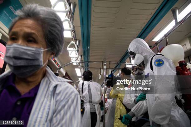 Soldiers from the 33rd Chemical Warfare Group dressed in a protective suit on a subway in Taipei, Taiwan on May 25, 2021.