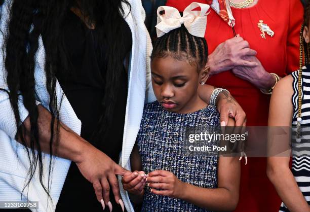 Gianna Floyd, George Floyd's daughter, holds the hand of her mother, Roxie Washington, while standing with members of the Floyd family prior to a...