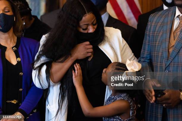 Gianna Floyd, George Floyd's daughter, looks up at her mother, Roxie Washington, as members of George Floyd's family met with House Democrats in the...