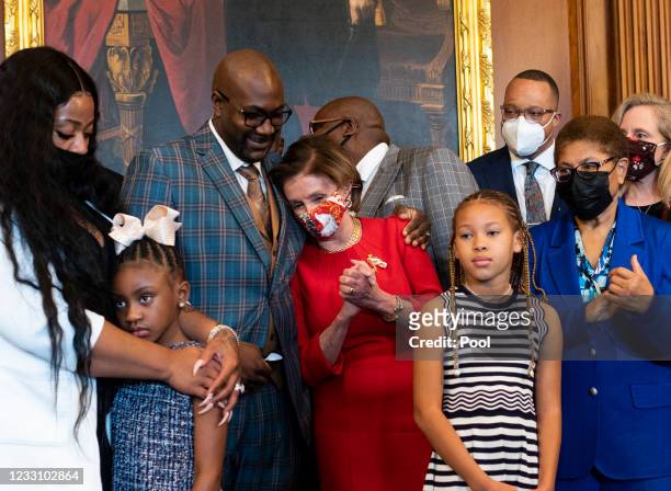 Philonise Floyd, George Floyd's brother, hugs Speaker of the House Nancy Pelosi prior to a meeting to mark the one anniversary of his death, May 25,...