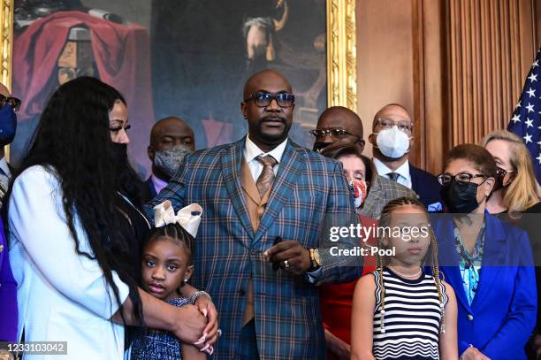 Philonise Floyd, George Floyd's brother, speaks to reporters while standing with members of the Floyd family prior to a meeting to mark the one...