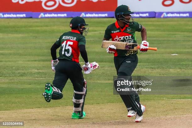 Bangladesh's Mushfiqur Rahim and Mohammad Mahmudullah run between the wickets during the second one-day international cricket match between...