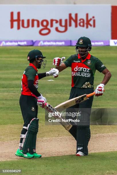 Bangladesh's Mushfiqur Rahim celebrates after scoring a half-century with teammate Mohammad Mahmudullah during the second one-day international...
