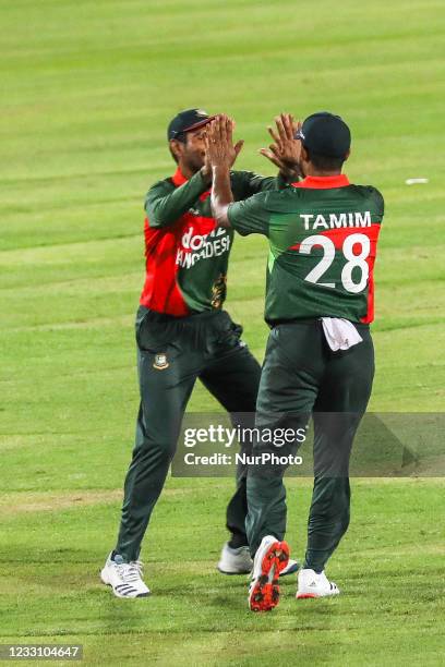 Bangladesh'sTamim Iqbal and Mohammad Mahmudullah celebrates after the dismissal of Sri Lanka's Dasun Shanaka during the second one-day international...