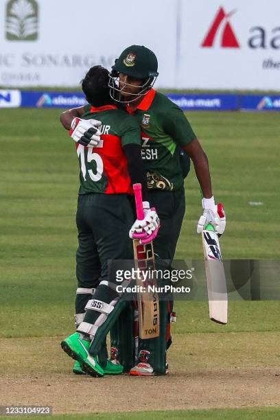 Bangladesh's Mushfiqur Rahim celebrates with his team mate Shaif Uddin after scoring a century during the second one-day international cricket match...