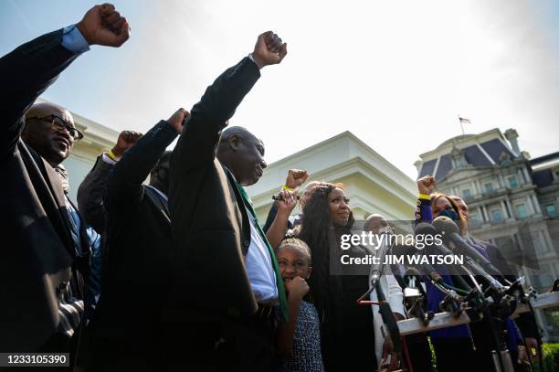 George Floyds family lawyer Ben Crump holds up his fist with family members outside the White House as George Floyds daughter Gianna Floyd calls out...