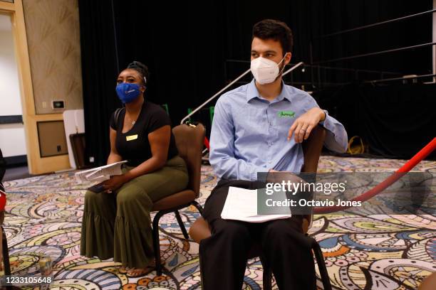 Job seekers Jamelah Daniels and Anthony Rice wait for an interview during the job fair at the Seminole Hard Rock Casino on May 25, 2021 in Tampa,...