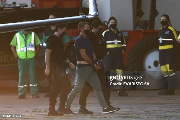 Italian Rocco Morabito, wanted for drug trafficking and mafia activities, arrives to Brasilia on May 25, 2021 escorted by federal police and interpol...