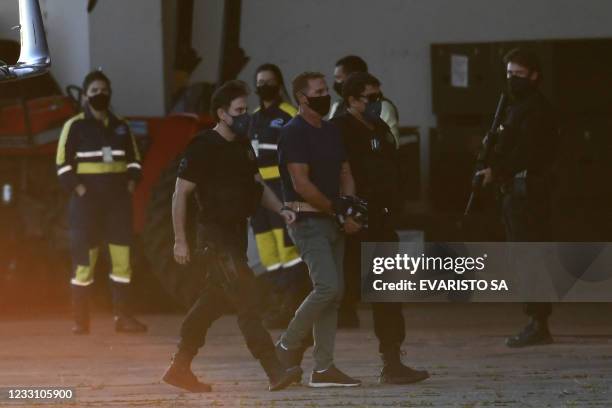 Italian Rocco Morabito, wanted for drug trafficking and mafia activities, arrives to Brasilia on May 25, 2021 escorted by federal police and interpol...