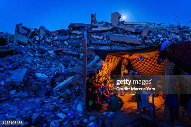 Dozens of Palestinian children and family members attend a candlelight vigil to condemn the killing of children and civilians, which is held over the...