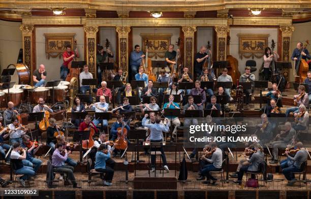 Members of Vienna's Philharmonic Orchestra perform during their rehearsal at Musikverein music hall in Vienna on May 20 prior to their appearance in...