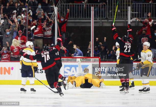 The Carolina Hurricanes celebrate after scoring the winning goal against the Nashville Predators in overtime in Game Five of the First Round of the...