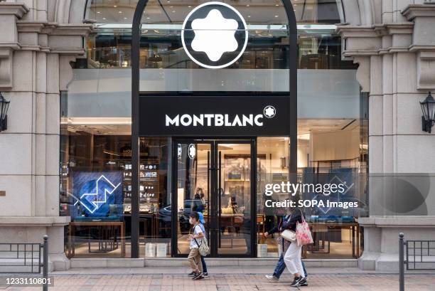 Pedestrians walk past the German manufacturer of luxury writing instruments, watches, jewellery Montblanc store seen Hong Kong.