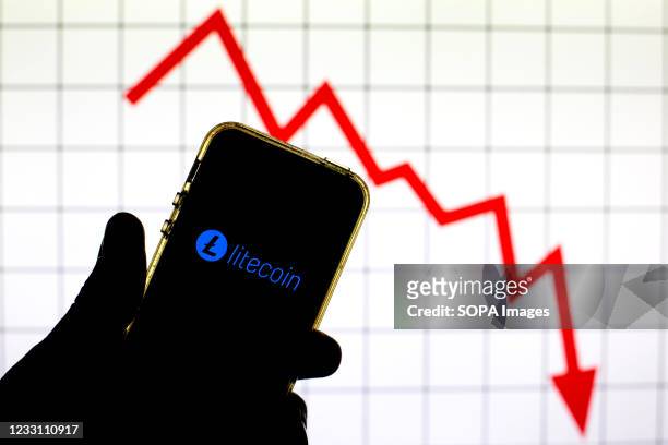 In this photo illustration a Litecoin cryptocurrency logo is seen on a smartphone screen.