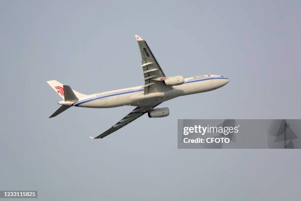 An Air China flight turns after takeoff at Beijing Capital International Airport on May 25, 2021.