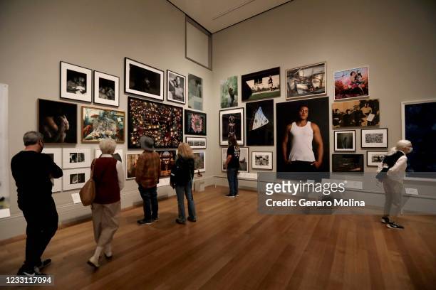 Visitors take in a new show titled, Photo Flux: Unshuttering LA, on the first day The Getty Center reopened to the public in over a year in Los...