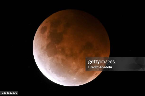 The full moon, known as a âsuper flower blood moonâ, is seen during its maximum lunar eclipse phase, in Sydney, Australia, on May 26, 2021. The full...