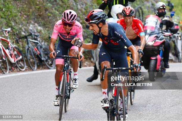 Team Ineos rider Colombia's Daniel Martinez encourages his teammate overall leader Team Ineos rider Colombia's Egan Bernal as they ride along with...