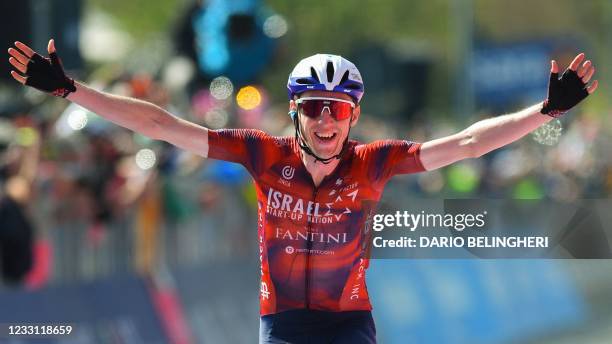 Team Israel Start-Up Nation rider Ireland's Daniel Martin celebrates as he crosses the finish line to win the 17th stage of the Giro d'Italia 2021...