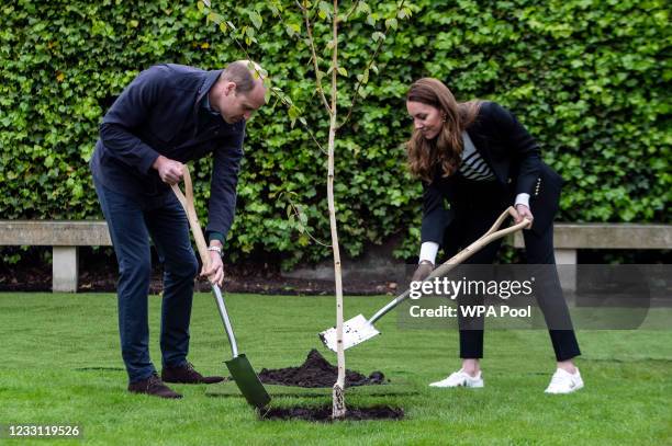 Prince William, Duke of Cambridge and Catherine, Duchess of Cambridge take part in planting a tree during a visit to the University of St Andrews on...