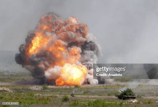 Explosion charge of the military machine demining is seen during military exercises at a training ground not far from the Rivne city, Ukraine, May...