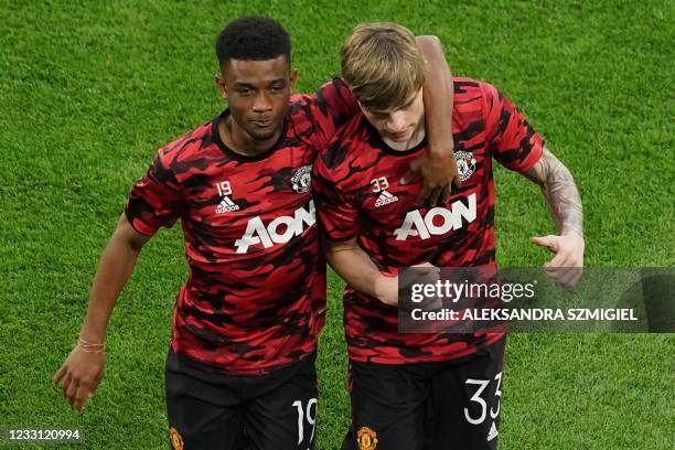 Manchester United's Ivorian midfielder Amad Diallo embraces Manchester United's English defender Brandon Williams before the UEFA Europa League final...