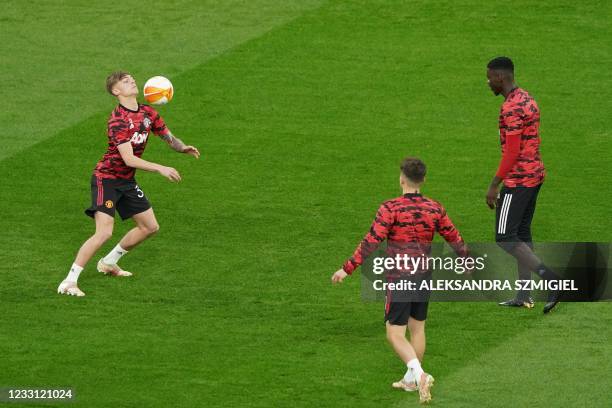 Manchester United's English defender Brandon Williams warms up with teammates before the UEFA Europa League final football match between Villarreal...