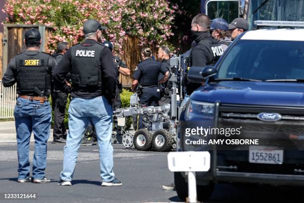 Emergency responders and San Jose Bomb Squad respond to a fire at the house of the suspect of a shooting, after nine people were reported dead...