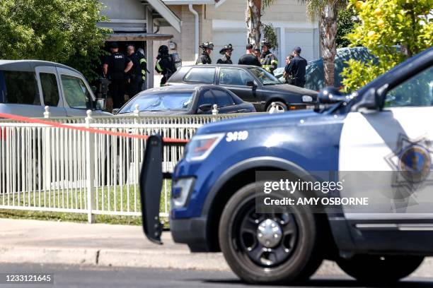 Emergency responders respond to a fire at the house of the suspect of a shooting, after nine people were reported dead including the shooter on May...