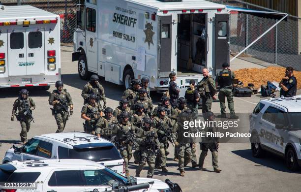 Tactical law enforcement officers move through the Valley Transportation Authority light-rail yard where a mass shooting occurred on May 26, 2021 in...
