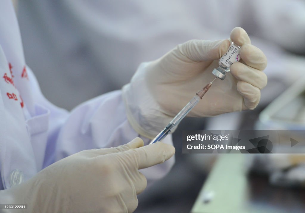 A health worker prepares a syringe with the COVID19 Vaccine...
