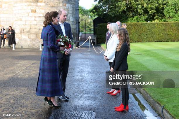 Britain's Prince William, Duke of Cambridge and Britain's Catherine, Duchess of Cambridge greet actor Tipper Seifert-Cleveland as they host a...