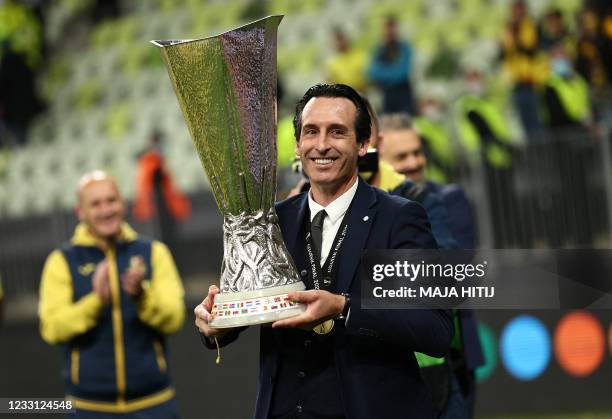 Villarreal's Spanish coach Unai Emery celebrates with the trophy after winning during the UEFA Europa League final football match between Villarreal...