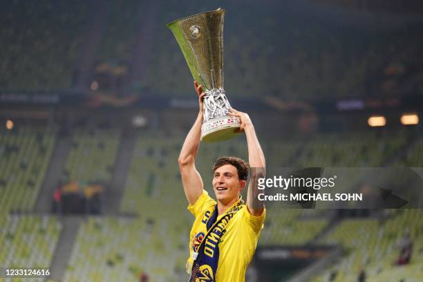 Villarreal's Spanish defender Pau Torres celebrates with the trophy after winning the UEFA Europa League final football match between Villarreal CF...