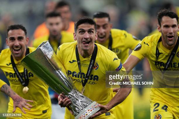 Villarreal's Spanish forward Gerard Moreno poses for pictures with the trophy after winning the UEFA Europa League final football match between...