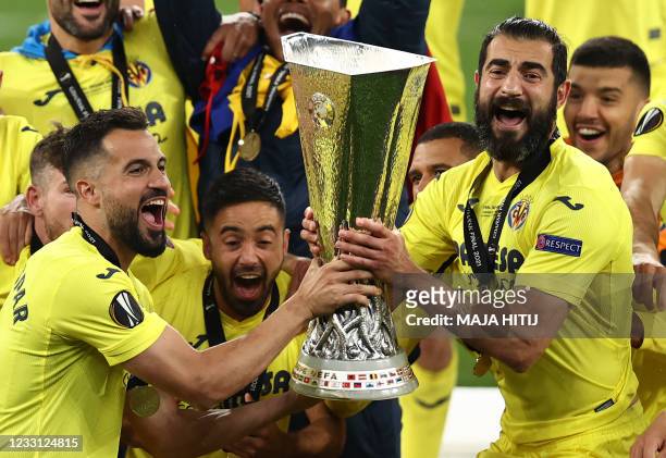Villarreal's Spanish defender Mario Gaspar and Villarreal's Spanish defender Raul Albiol celebrate with the trophy after winning the UEFA Europa...