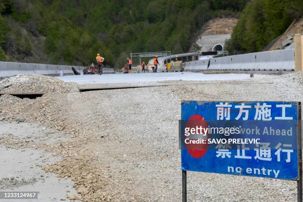 Construction laborers work on the new highway connecting the city of Bar on Montenegros Adriatic coast to landlocked neighbour Serbia, on May 11 near...