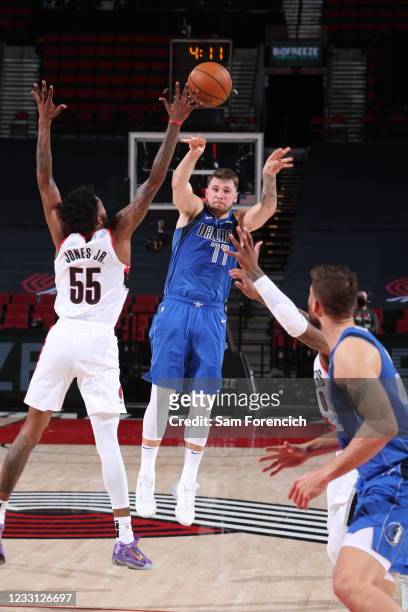 Derrick Jones Jr. #55 of the Portland Trail Blazers blocks the ball during the game against Luka Doncic of the Dallas Mavericks on March 19, 2021 at...