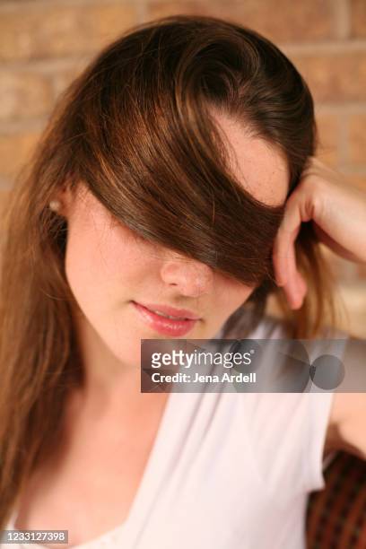 woman covering face with hair, woman hiding eyes - viso nascosto foto e immagini stock