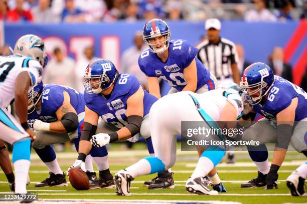 New York Giants quarterback Eli Manning lines up over New York Giants center Shaun O'Hara during the first half of the Carolina Panthers vs New York...