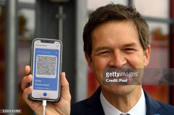 Ronald Fritz, IBM project manager, shows the example of a digital vaccination pass during a press conference at the Babelsberg vaccination center on...