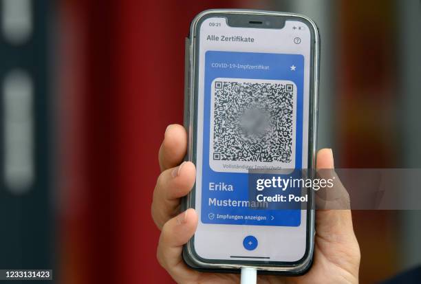 Holger Rostek, deputy chairman of the Brandenburg Association of Statutory Health Insurance Physicians , shows the digital vaccination pass during a...