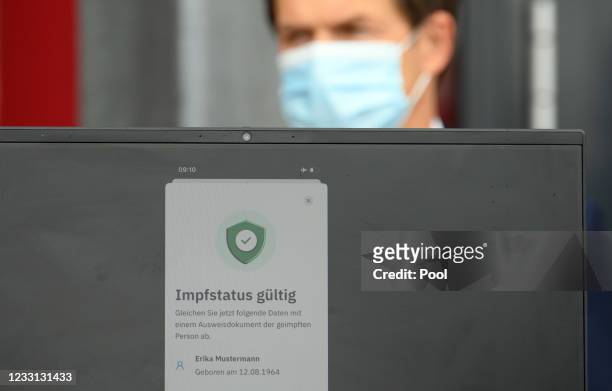 Ronald Fritz, IBM project manager, stands behind a computer monitor during a press conference at the Babelsberg vaccination center, on which the...
