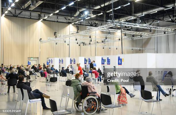 People wait for their vaccination against COVID-19 in the Babelsberg vaccination center, following the presentation of the digital vaccination pass...
