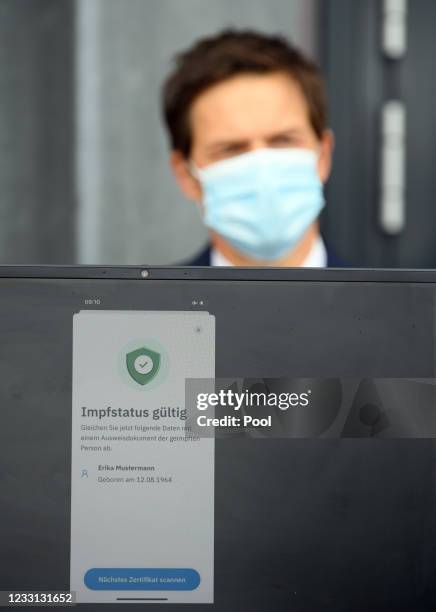 Ronald Fritz, IBM project manager, stands behind a computer monitor during a press conference at the Babelsberg vaccination center, on which the...