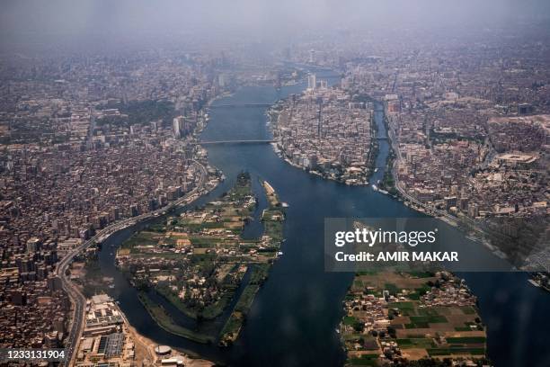 This picture taken on May 14, 2021 shows an aerial view of Egypt's capital Cairo and its twin city of Giza , showing the historic old Cairo district...