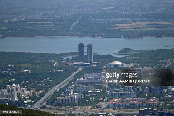 General view taken from a hilltop shows the Pakistan's capital city Islamabad and its suburbs, on May 27, 2021.