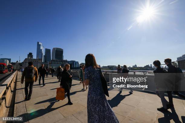 Commuters walk across London Bridge towards the City of London square mile financial district in London, U.K., on Thursday, May 27, 2021. More than...